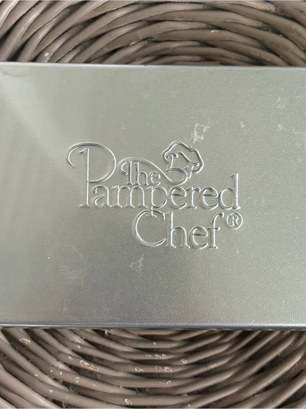 The Pampered Chef Silver Embossed Logo Tin Contains 8 Creative Cutters Set
